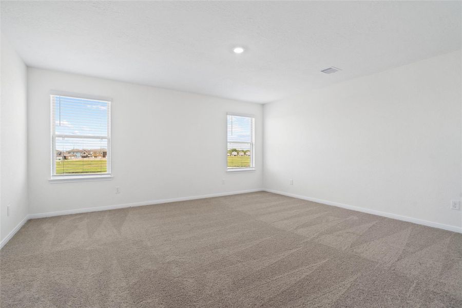 Unwind after a long day in this stunning primary suite! This spacious retreat features plush carpeting, warm-toned walls, high ceilings, recessed lighting, and large windows with privacy blinds for comfort and tranquility. Unwind after a long day in this stunning primary suite! This spacious retreat features plush carpeting, warm-toned walls, high ceilings, recessed lighting, and large windows with privacy blinds for comfort and tranquility.