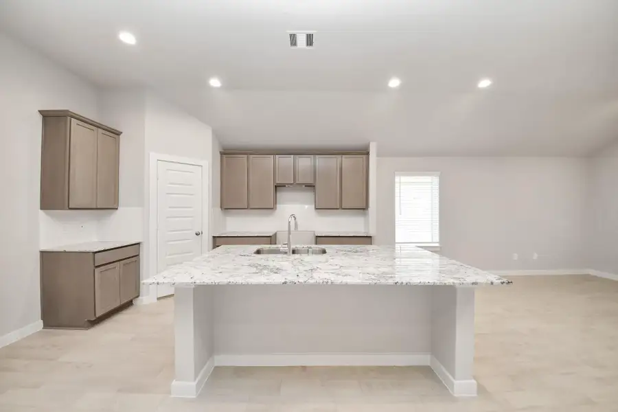 This generously spacious kitchen is a dream realized! Sample photo of completed home with similar floor plan. Actual colors and selections may vary.