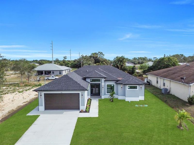 Front exterior of a new home in , Lehigh Acres, FL, highlighting curb appeal (Image 21).