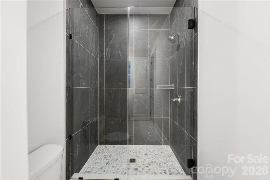 Modern Tile Design at Frameless Primary Shower.
