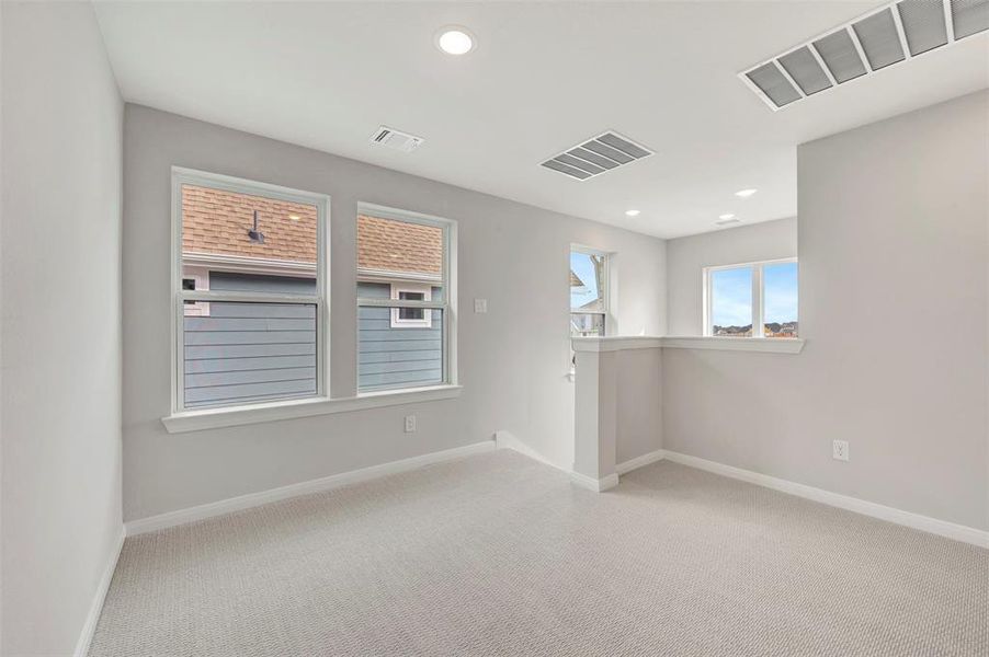 Spare room featuring light carpet and recessed lighting