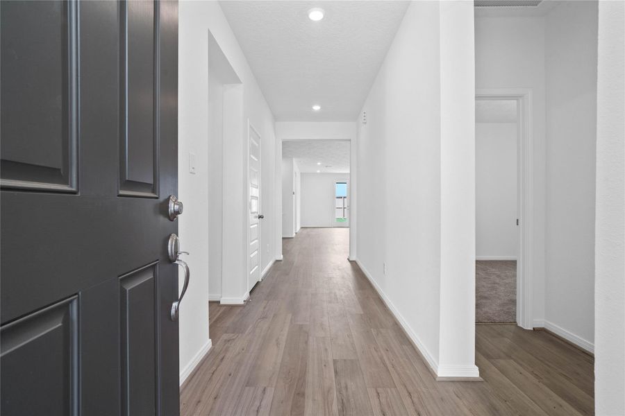 Welcome inside this lovely home of 12819 Autumn Woods! Upon entering you find a lovely corridor showcasing custom paint, beautiful Layton Lake vinyl plank floors, modern archways, high ceilings, and ample lighting!