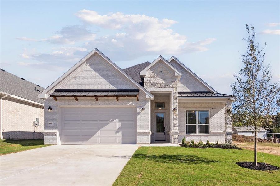 Craftsman inspired home with a front yard and a garage