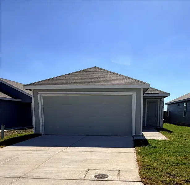 Single story home featuring a garage and concrete driveway Single story home featuring a garage and concrete driveway