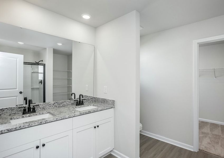 The master bathroom features a dual-vanity sink.