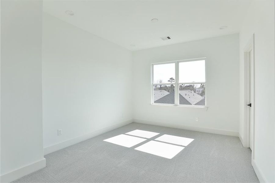 Relax in the cozy comfort of carpeted floors in this secondary bedroom.