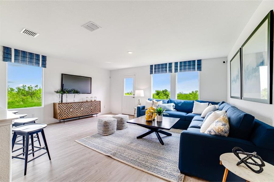 Living room with light wood-style flooring and baseboards Living room with light wood-style flooring and baseboards