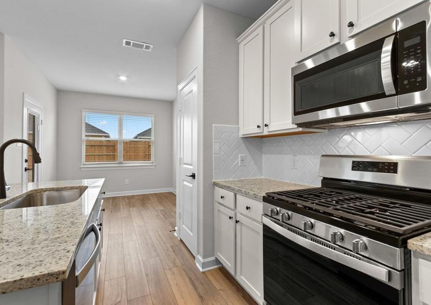 This kitchen has natural light from several windows.