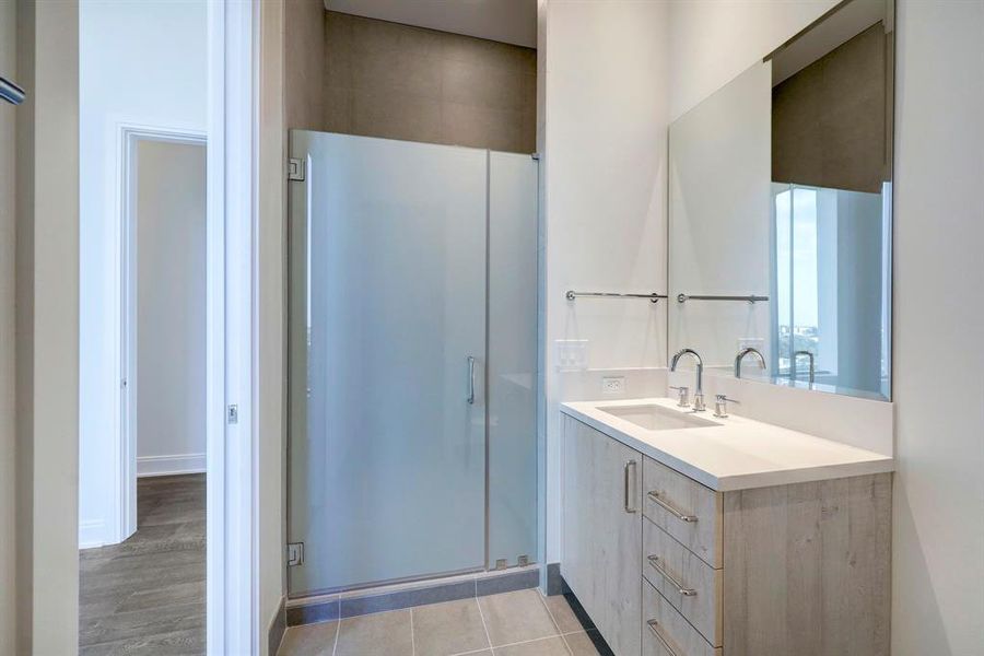 Inside the secondary suite's lovely bathroom, you'll find a walk-in shower with frosted glass doors and a roomy custom vanity.