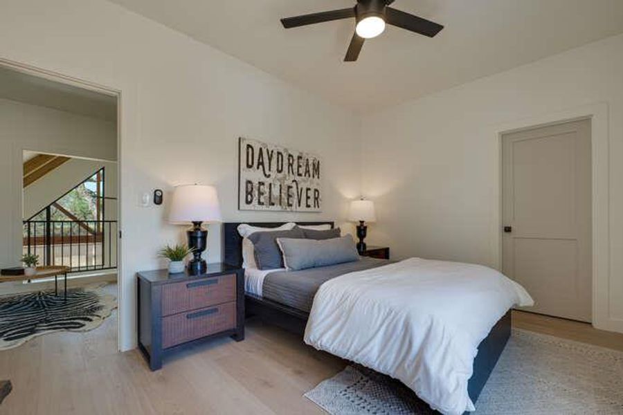 Bedroom with light wood-style floors and ceiling fan