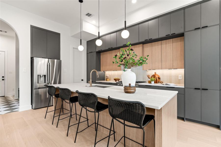 This oversized kitchen features luxury Bosch appliances, Taj Mahal counters, and more than enough storage space with three layers of European soft close cabinetry. This oversized kitchen features luxury Bosch appliances, Taj Mahal counters, and more than enough storage space with three layers of European soft close cabinetry.