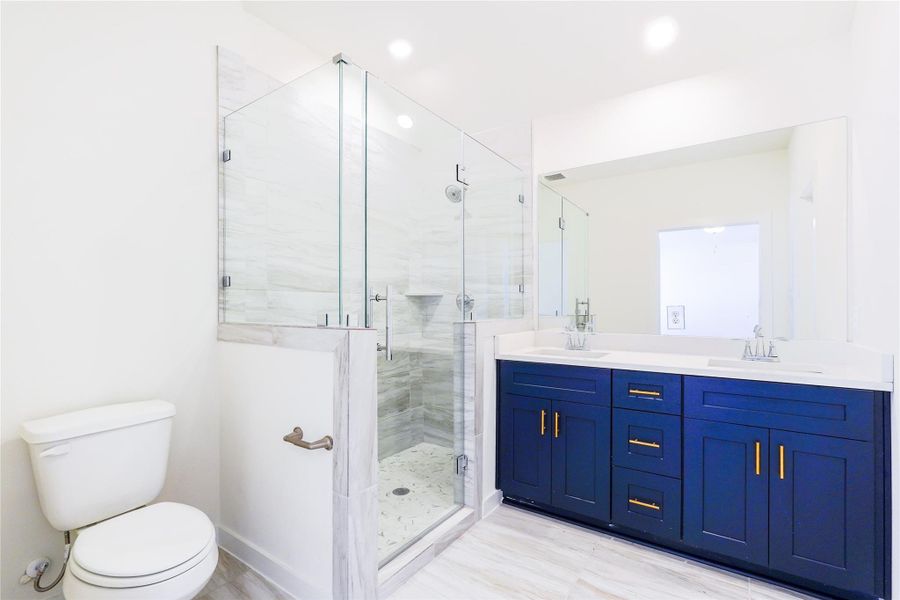 This room features neutral carpeting, a large window for natural light, and a white door. The walls and ceiling are painted white, giving it a bright and airy feel.