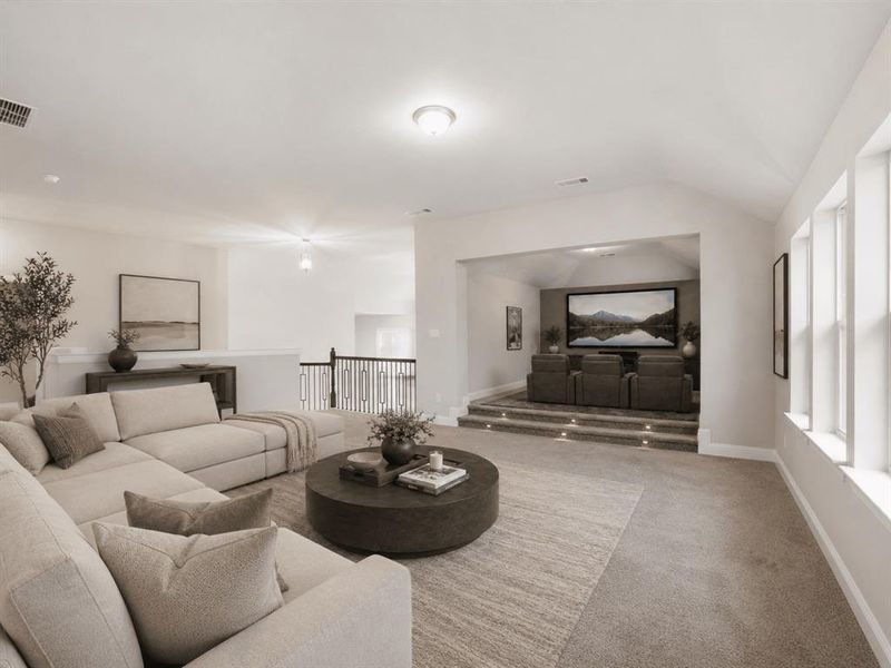 Carpeted media room featuring a tiered viewing area with recessed lighting, a large screen, and a vaulted ceiling