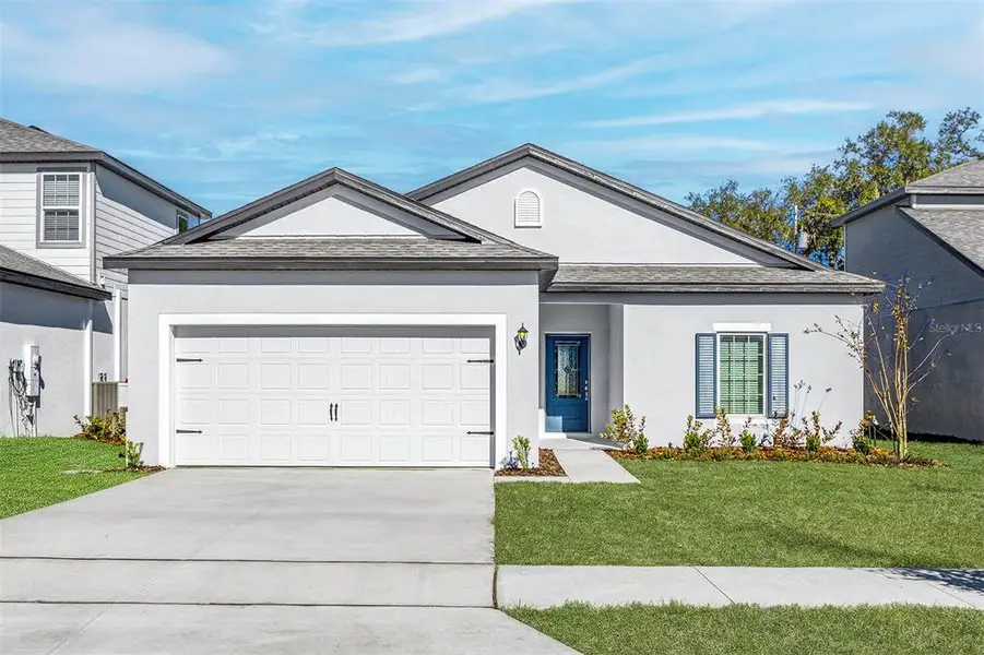 Front exterior of a new home in Tula Parc, Astatula, FL, highlighting curb appeal (Image 2). Front exterior of a new home in Tula Parc, Astatula, FL, highlighting curb appeal (Image 2).