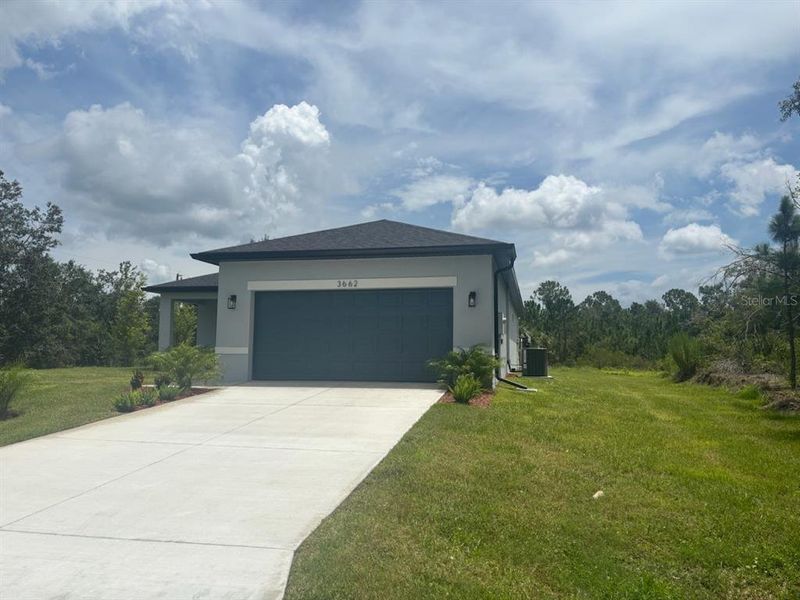 Front exterior of a new home in , North Port, FL, highlighting curb appeal (Image 2). Front exterior of a new home in , North Port, FL, highlighting curb appeal (Image 2).