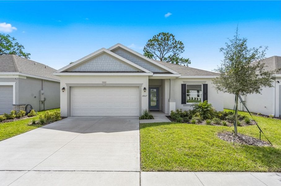 Front exterior of a new home in Huntington Park, Titusville, FL, highlighting curb appeal (Image 1). Front exterior of a new home in Huntington Park, Titusville, FL, highlighting curb appeal (Image 1).