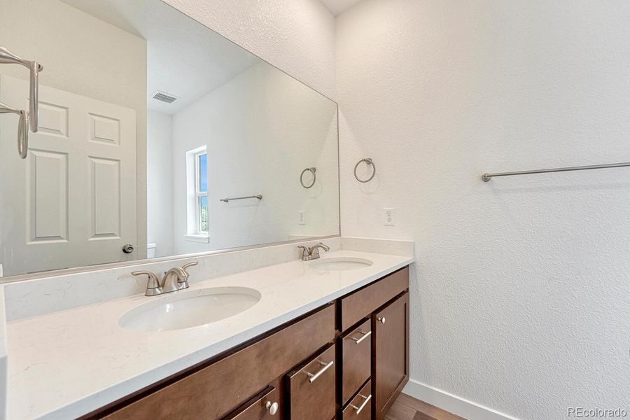 En suite primary bathroom offers double vanity with undermount sinks. Pick your cabinetry, stone countertop, flooring and paint to suite your style.