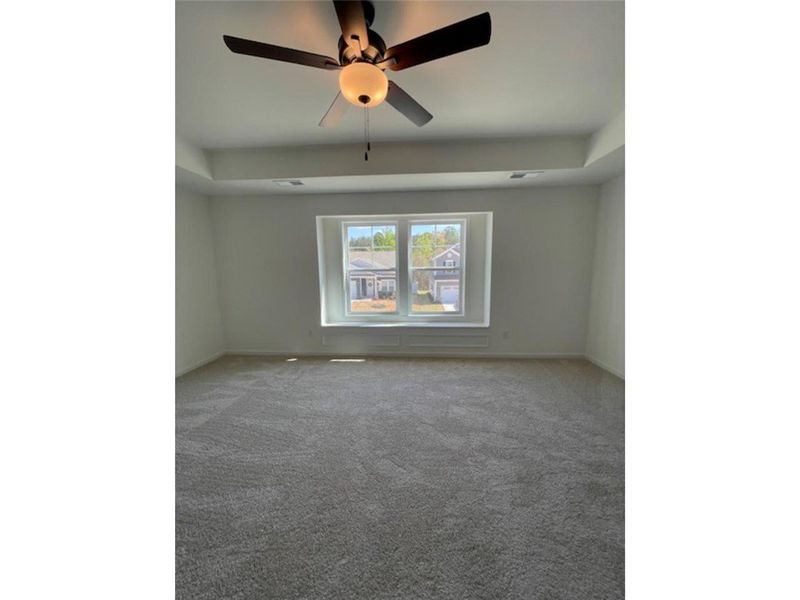 This spacious bedroom offers ample natural light a