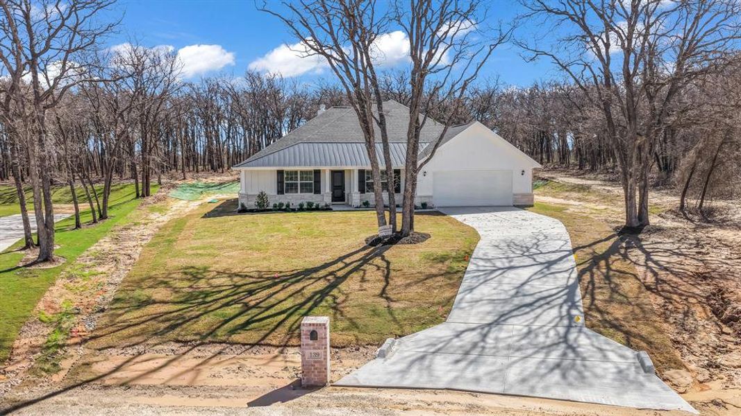 Front exterior of a new home in , Poolville, TX, highlighting curb appeal (Image 22).