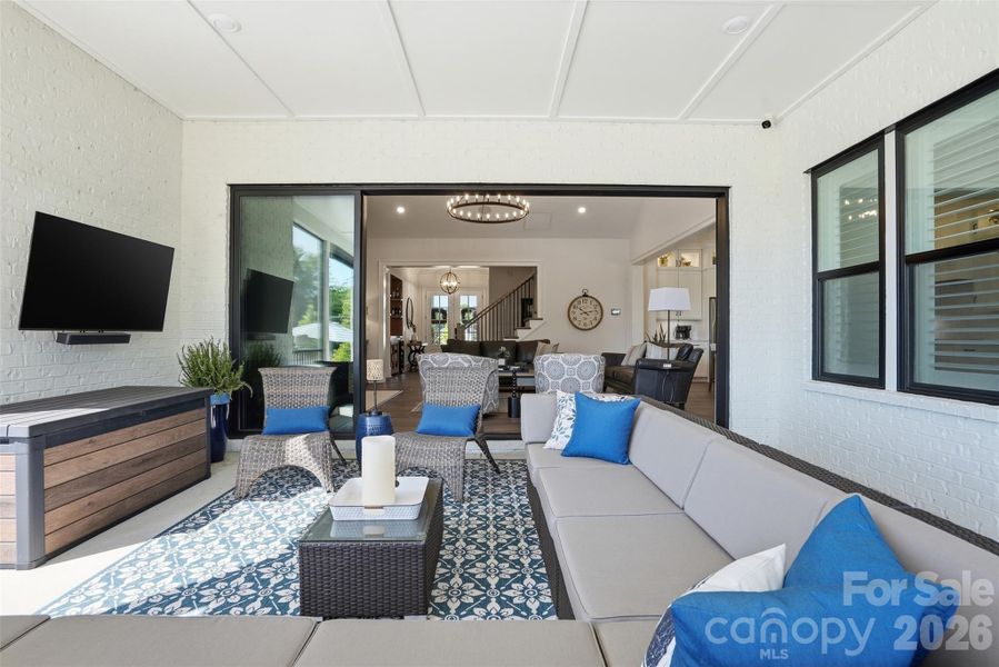 Covered, screened porch that opens into great room