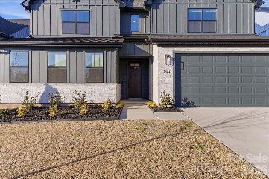 Front exterior of a new home in Windell Woods, Tega Cay, SC, highlighting curb appeal (Image 26).