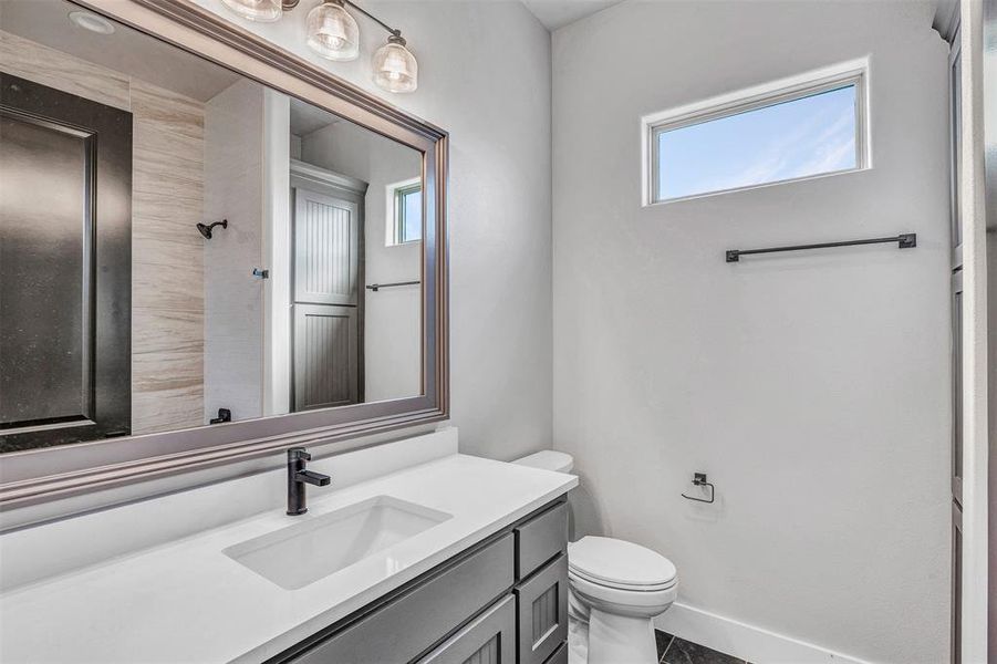 Bathroom featuring vanity and toilet