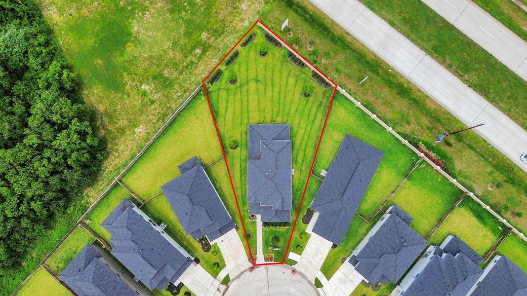 An aerial view of a spacious subdivision lot, highlighting a well-maintained yard and a fully fenced perimeter, offering both privacy and expansive outdoor space. An aerial view of a spacious subdivision lot, highlighting a well-maintained yard and a fully fenced perimeter, offering both privacy and expansive outdoor space.