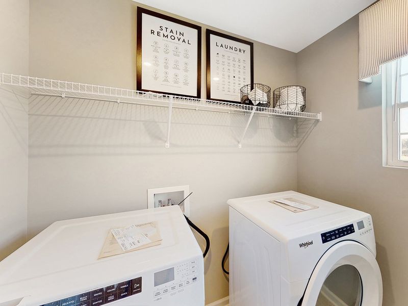 A laundry room with a washer and dryer. A laundry room with a washer and dryer.
