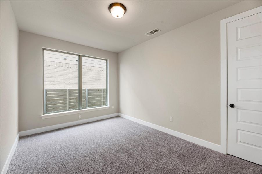 Carpeted spare room with baseboards