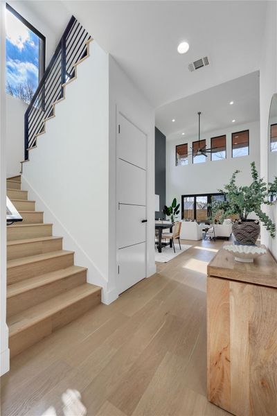 Stairway featuring wood finished floors and recessed lighting