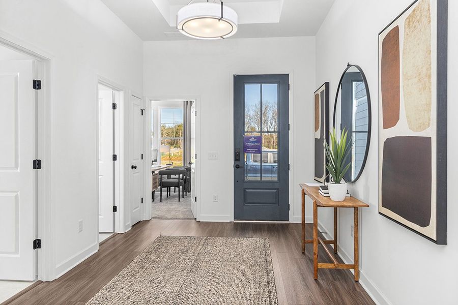 A room with white walls and a table with a plant on it.