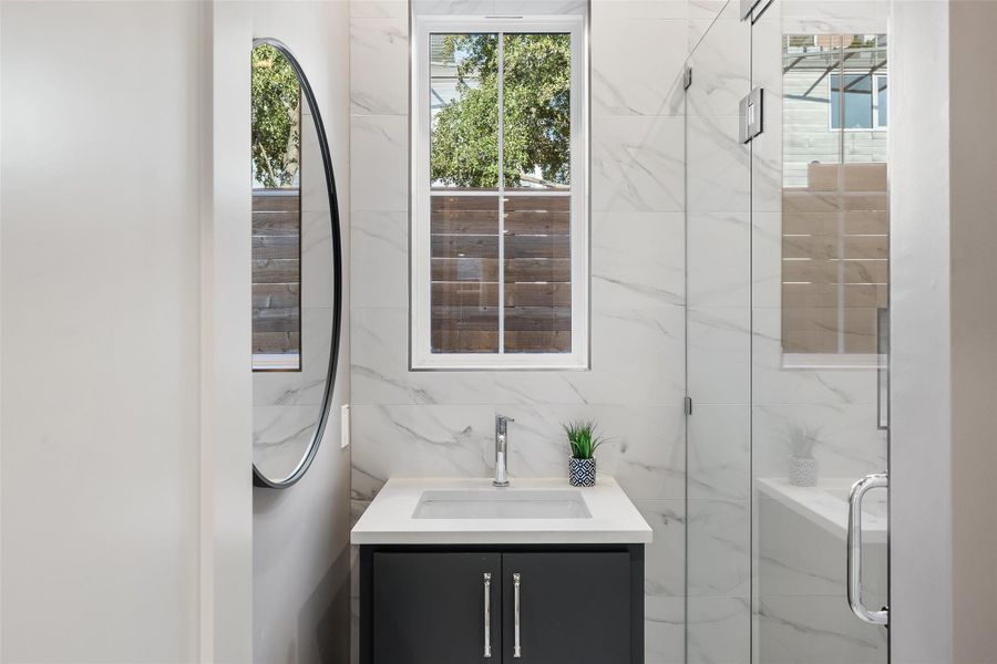 Bathroom featuring vanity and walk in shower