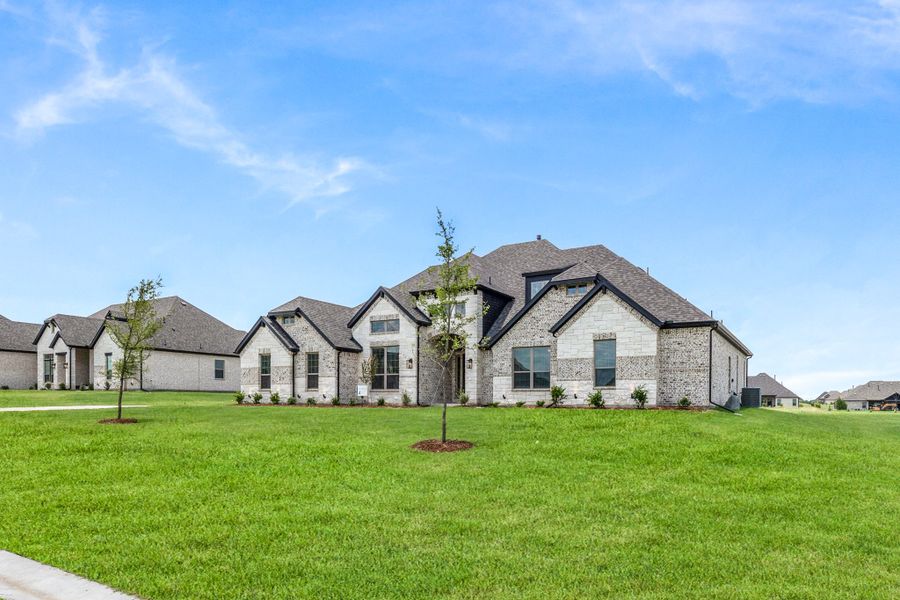 Front exterior of a new home in Heritage, McLendon-Chisholm, TX, highlighting curb appeal (Image 16).