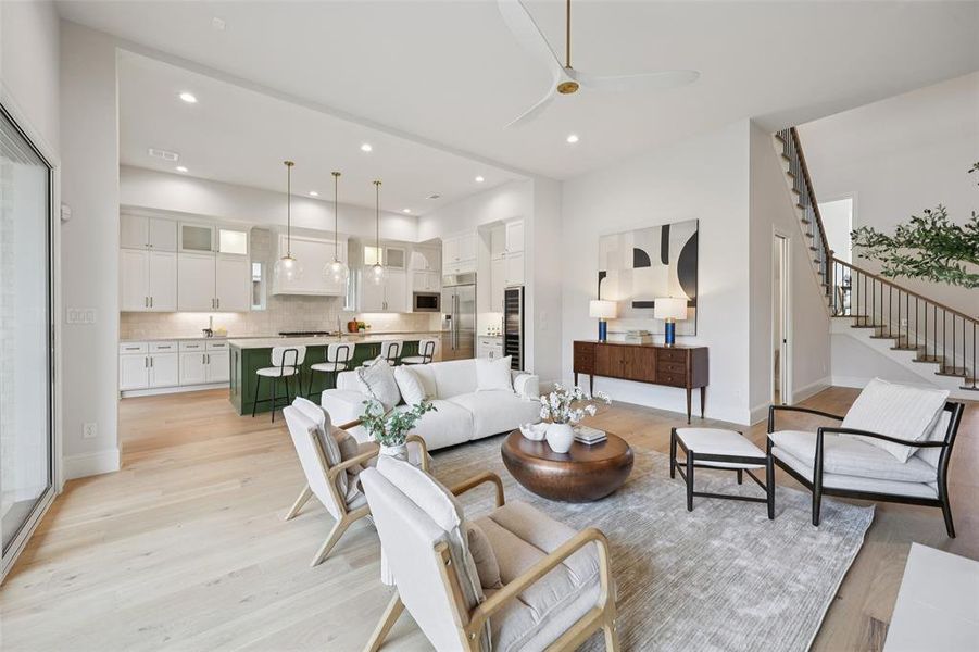 Living area with ceiling fan, light wood-type flooring, wine cooler, and recessed lighting