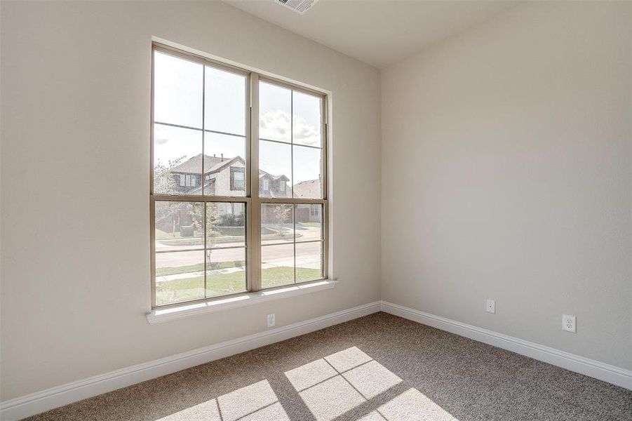 Carpeted spare room with a wealth of natural light