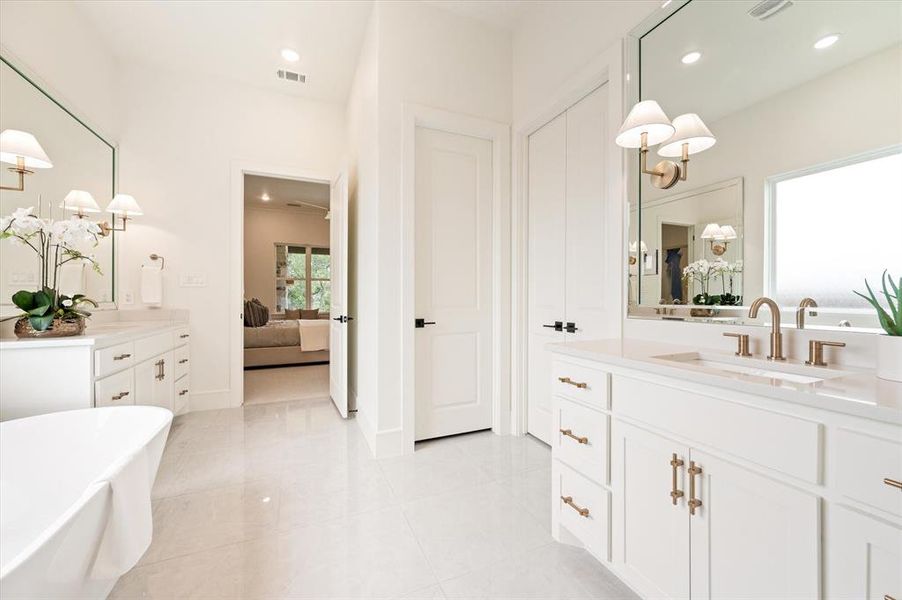 Bathroom with vanity, a washtub, and tile patterned floors