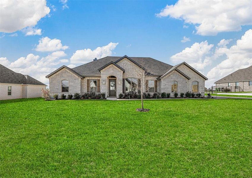 French country style house with a front yard