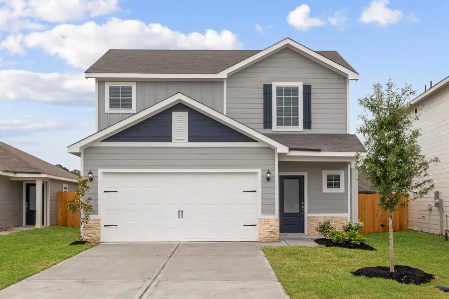 Front exterior of a new home in Magnolia Woods, Magnolia, TX, highlighting curb appeal (Image 1).