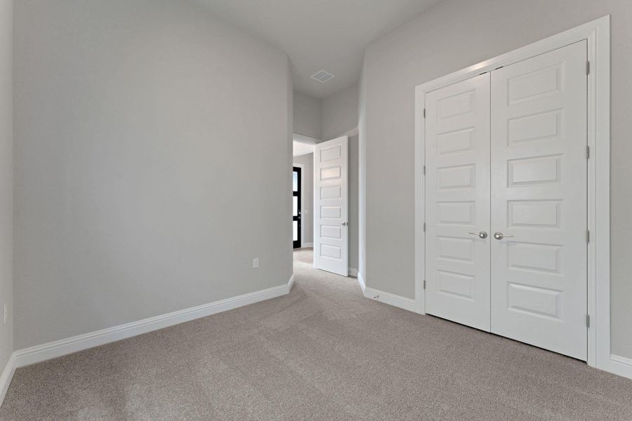 Unfurnished bedroom with carpet floors and a closet Unfurnished bedroom with carpet floors and a closet