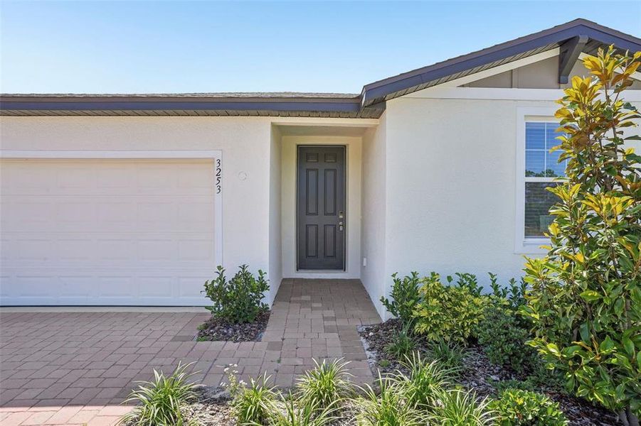 Front exterior of a new home in Lake Deer Estates - Signature Series, Poinciana, FL, highlighting curb appeal (Image 22). Front exterior of a new home in Lake Deer Estates - Signature Series, Poinciana, FL, highlighting curb appeal (Image 22).