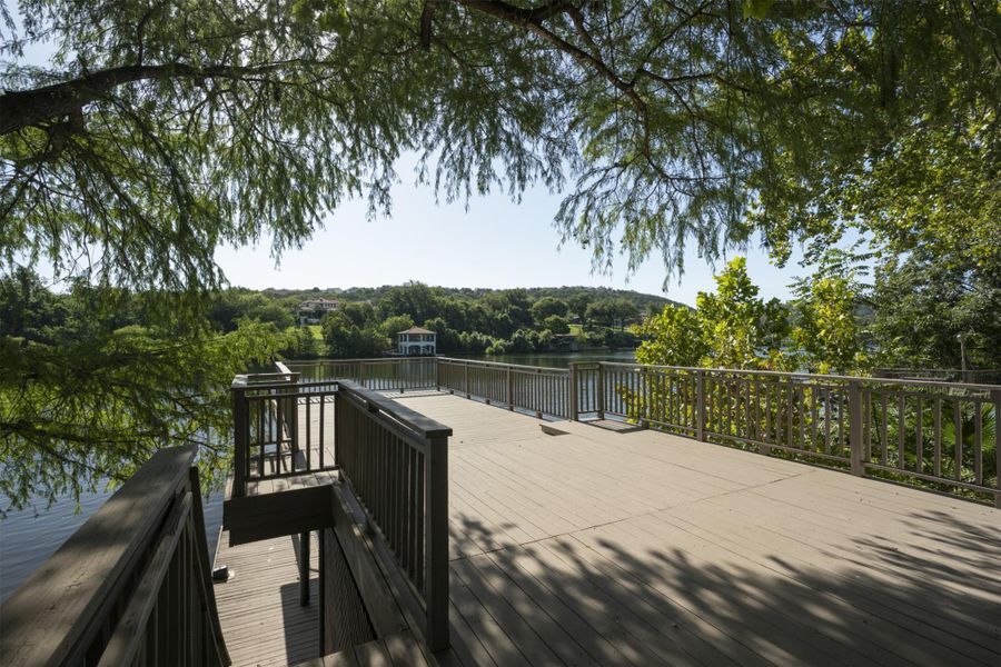 Deck with a water view and a forest view