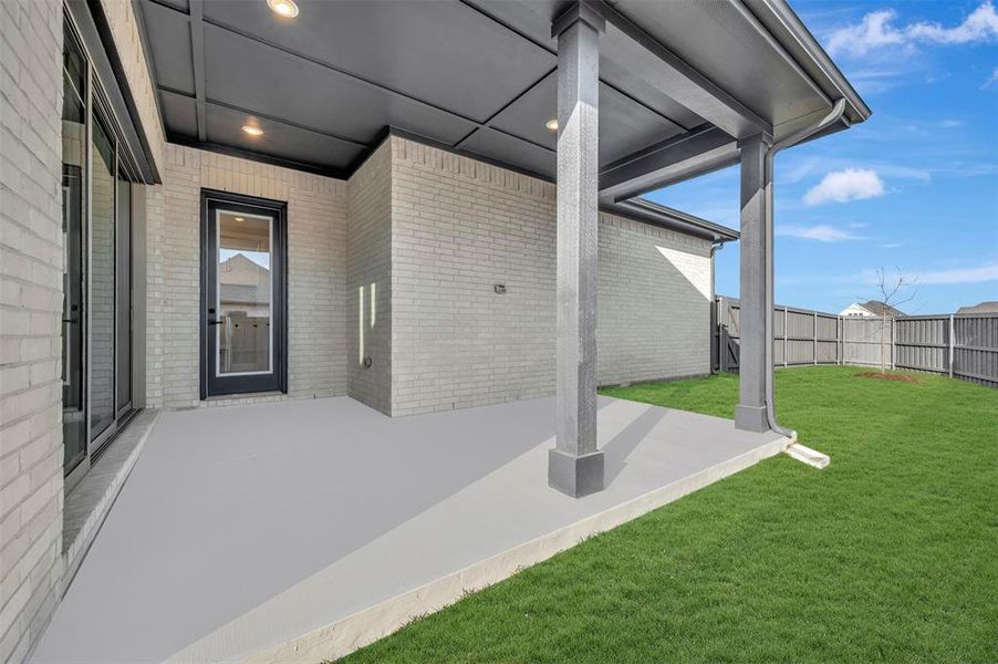 Fenced backyard featuring a patio area Fenced backyard featuring a patio area