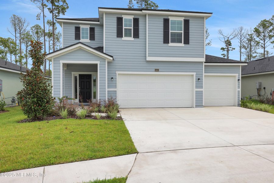 Front exterior of a new home in Cordova Palms, St. Augustine, FL, highlighting curb appeal (Image 15).
