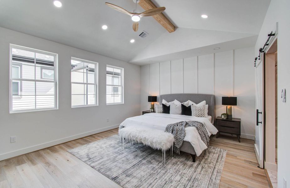 Spacious, light-filled primary suite has 13' vaulted ceilings, remote controlled smart fan, French oak floors.