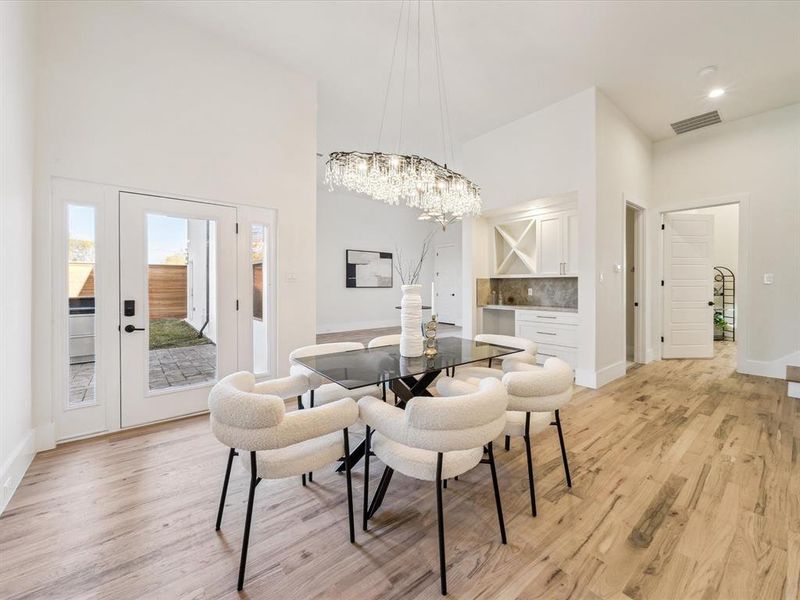 Dining space with a chandelier and light hardwood / wood-style flooring