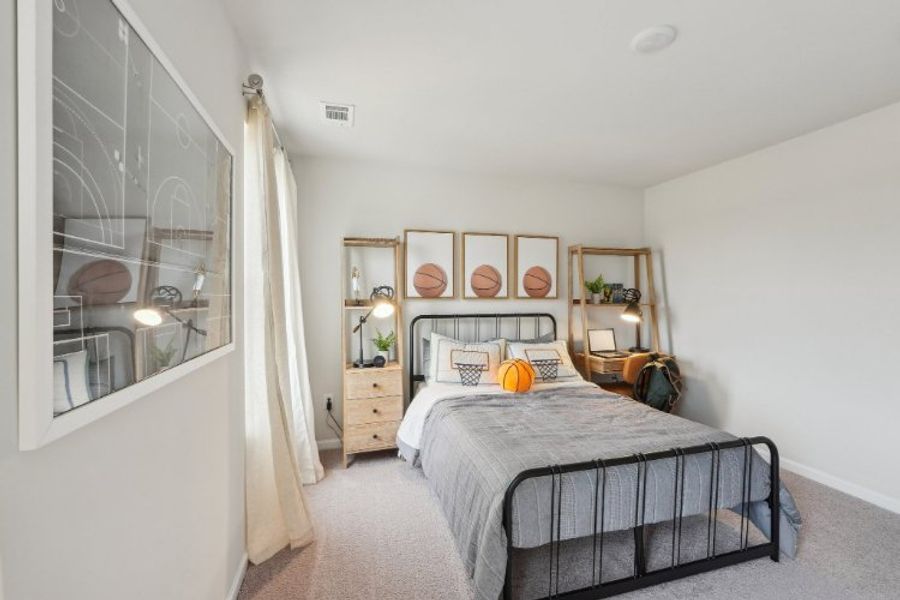 A bedroom with a bed and a window.