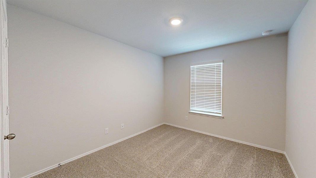 Carpeted room featuring a single window with blinds, recessed lighting, and a neutral color palette