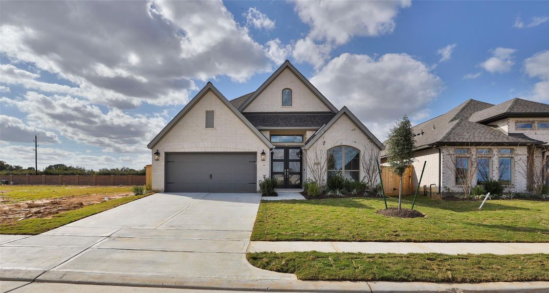 Front exterior of a new home in Everly 50', Tomball, TX, highlighting curb appeal (Image 2).