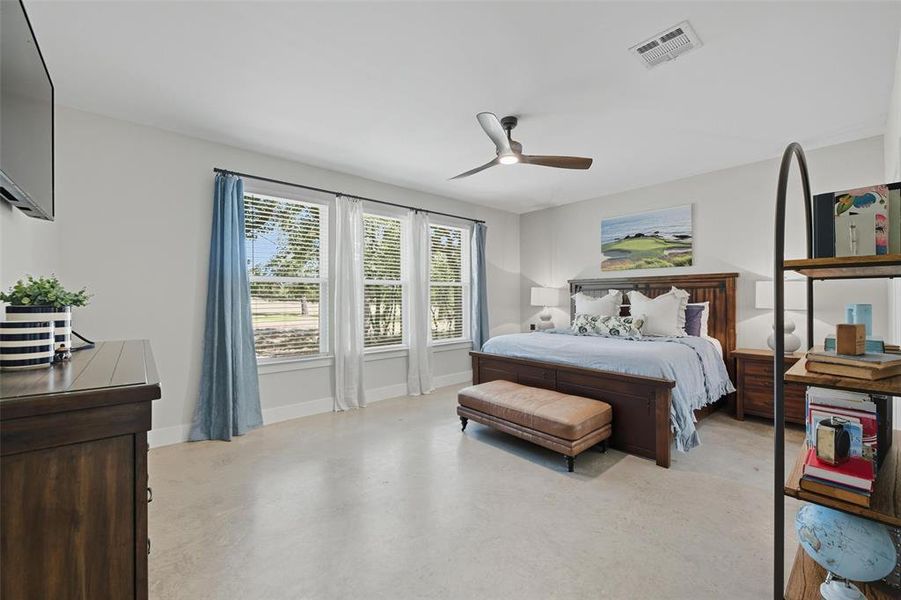 Bedroom with finished concrete floors and a ceiling fan Bedroom with finished concrete floors and a ceiling fan