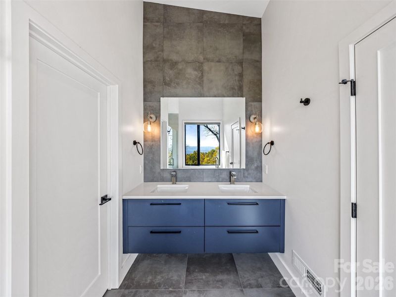 Room for two at the primary suite vanity. Room for two at the primary suite vanity.